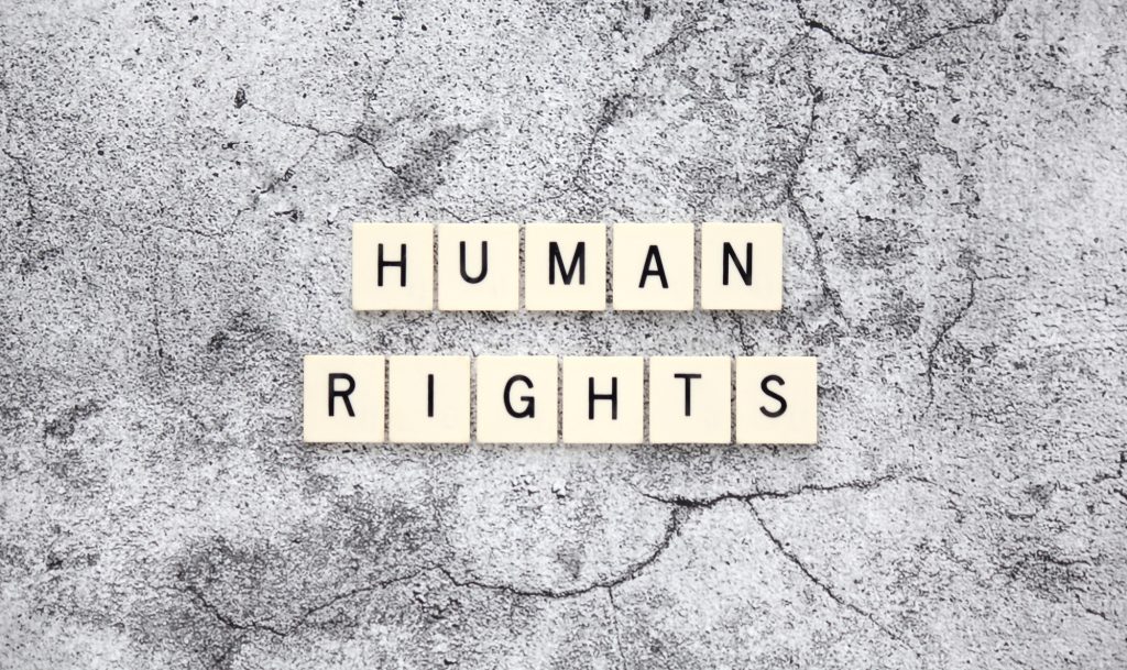 Human Rights word tiles on a cracked concrete background
