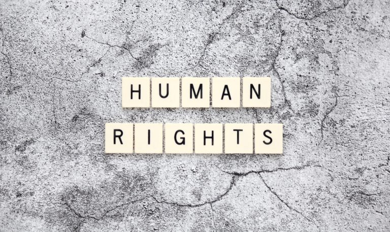 Human Rights word tiles on a cracked concrete background