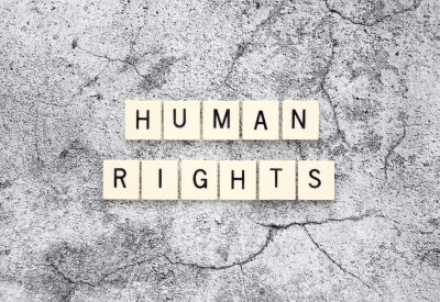 Human Rights word tiles on a cracked concrete background