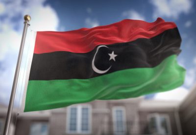 libya-flag-3d-rendering-blue-sky-building-background