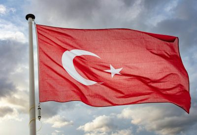 Turkey flag waving against cloudy sky